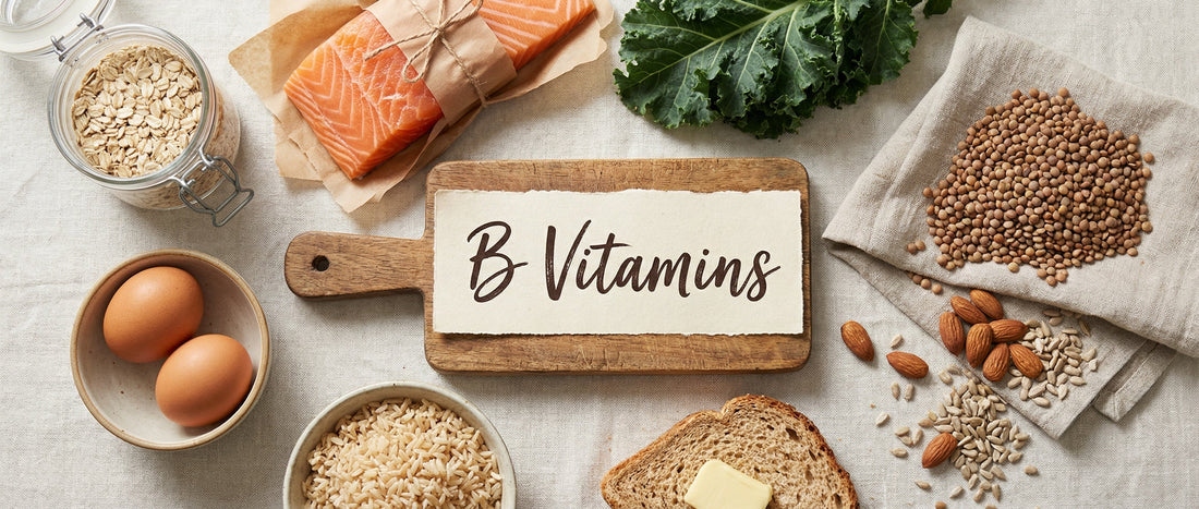 Whole food sources commonly associated with B vitamins, arranged in a clean editorial flat-lay style